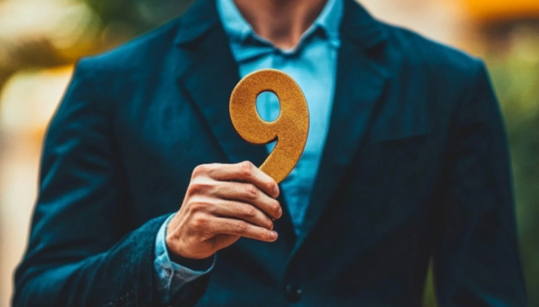 Person holding number 9 representing famous enneagram 9 peacemaker personality type.