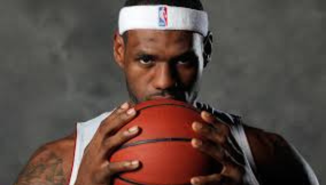 LeBron James holding basketball showing famous ESFJ athlete and community leader.
