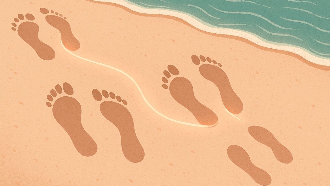 Footprints walking together on beach illustrating what kindred spirits are and their connected journeys.